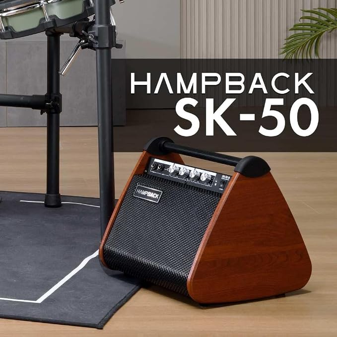 A HAMPBACK SK-50 portable speaker with a brown wood-grain finish and black mesh grille, shown on a wooden floor next to a drum kit stand. A dark overlay with white text reads 'HAMPBACK SK-50'.